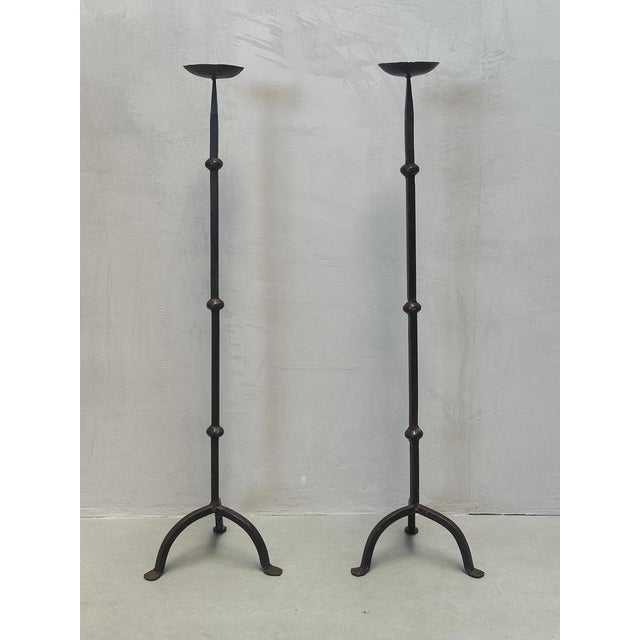 Brutalist iron floor candle holder. Its minimalist design, featuring a stable base and ethnic influences, makes it a...