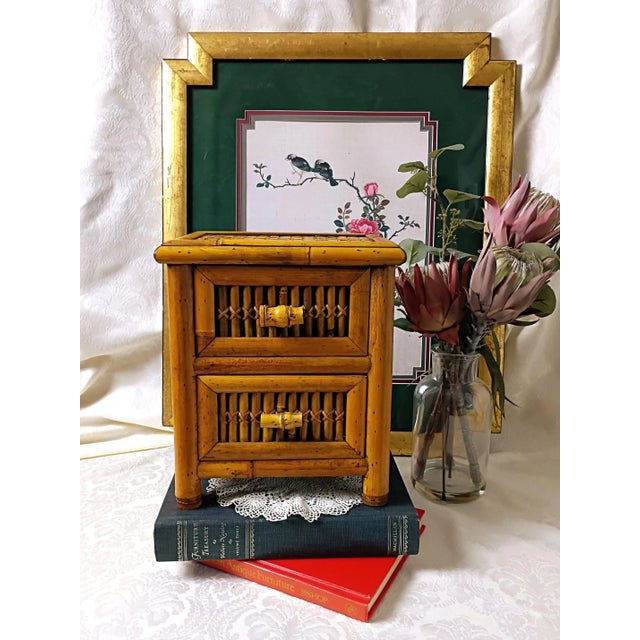 This vintage small chest of drawers bamboo coffee bar station showcases a classic mid-century geometric silhouette...
