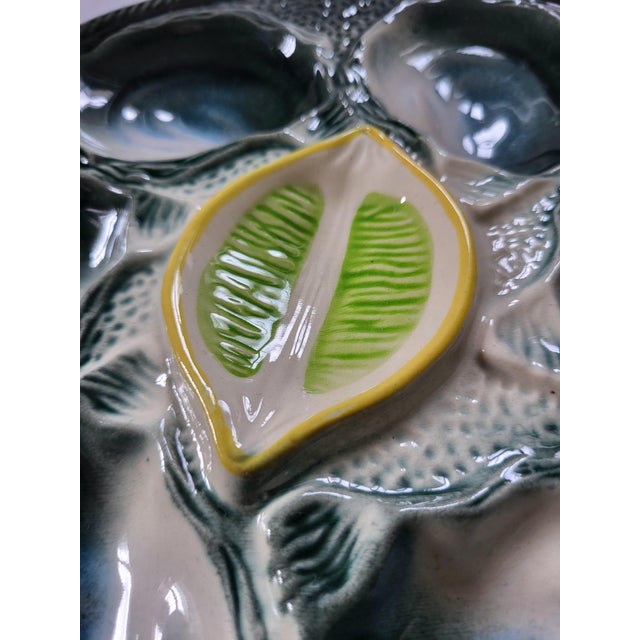 A striking, highly collectible mid-century 7-piece French majolica seafood service crafted by the historic Faiencerie de...