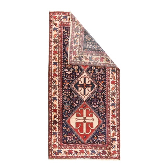 This rustic kellegi (long rug) shows a three section pole medallion in red and ivory, with sawtooth edges and hooked...