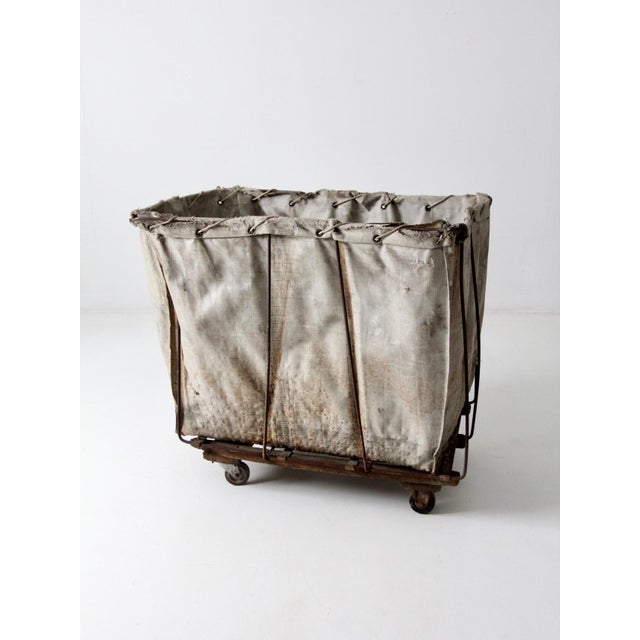 This vintage industrial laundry cart from Meese Inc. features the original Shamrock-branded canvas bag with rope ties at...