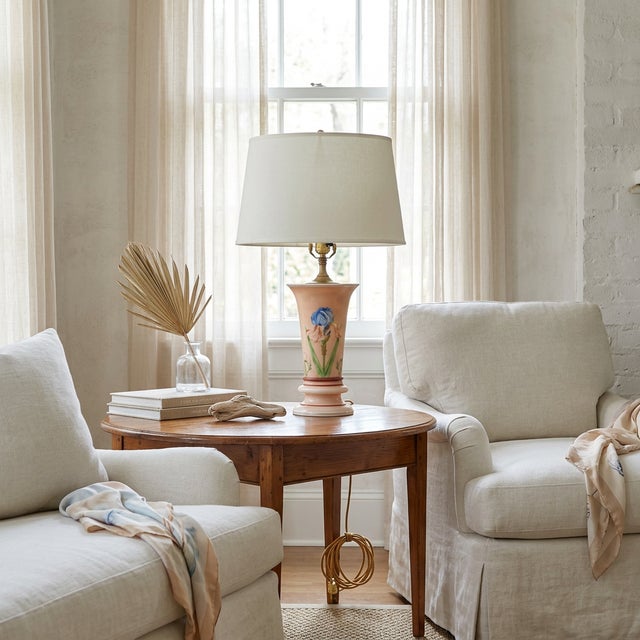 A charming mid-century vase-form table lamp in blush satin glass, hand-painted with a vivid blue iris and green stem...