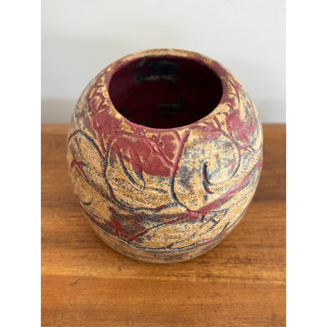 Small studio pottery seed pot vase with an abstract etching and blue and red glaze over a tan base. Most items found at...