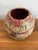Small studio pottery seed pot vase with an abstract etching and blue and red glaze over a tan base. Most items found at...