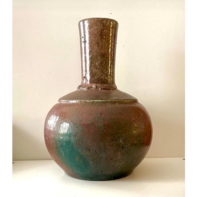 A beautifully expressive vintage studio pottery vase distinguished by its sculptural proportions and richly layered,...