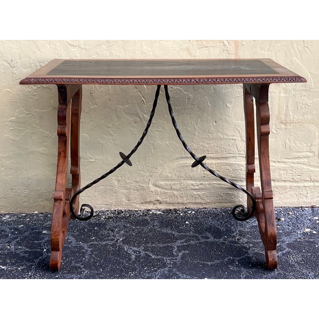 19th century Spanish trestle table in walnut. This piece has a great scale, lovely carved lyre legs and beautiful ebonized...