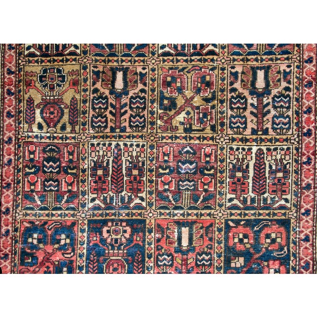 A wonderful early 20th century Persian Bakhtiari rug with a hand-woven patchwork pattern with myriad cypress trees and...