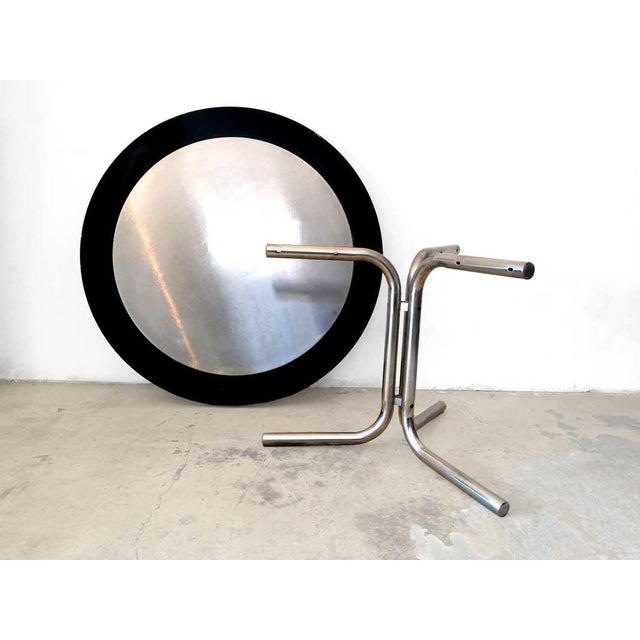 "Desco" model dining table designed by Achille Castiglioni for Zanotta in the 1970s. Round top in satin steel and black...