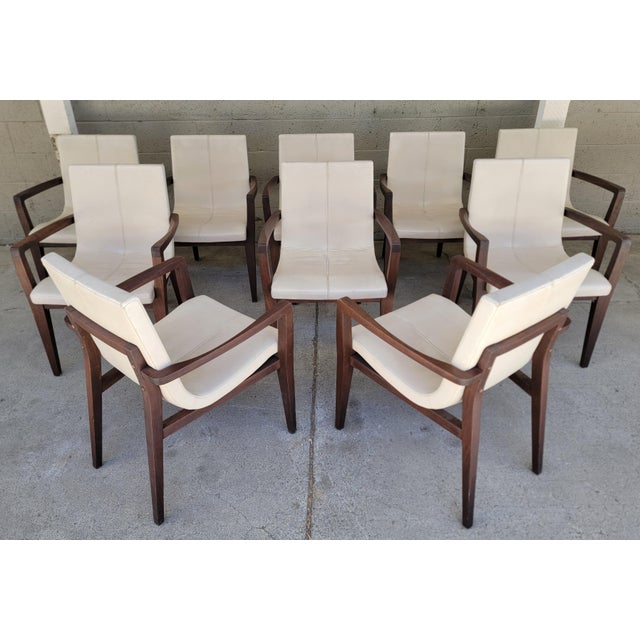 A set of 10 authentic "Siren" dining arm chairs by Holly Hunt. Retaining Studio H metal label on underside of each chair....