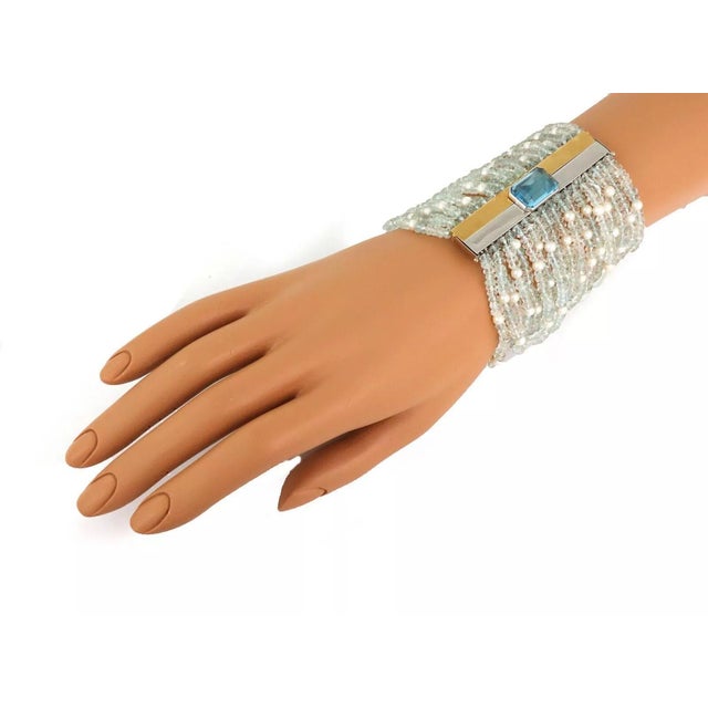 This is an eye catching Estate bracelet, the long push in bar is crafted from 18k yellow and white gold. Attached to the...