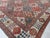 A late 19th century Persian Bakhtiari antique carpet with a bold pattern overall of stepped serrated-edged medallions in...