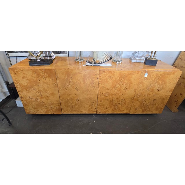 Gorgeous 70s era burl wood credenza with beautiful grain pattern on front doors with 4 shelves, 2 drawers inside and sits...