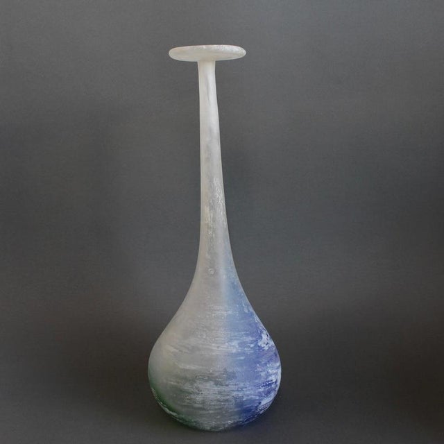 Free-blown Murano glass bottle / vase with a bulbous ovoid body which rises to a long, tapering neck and an asymmetrical,...