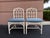 A pair of vintage McGuire dining chairs in the classic arched lattice design. Finished in white painted rattan with...