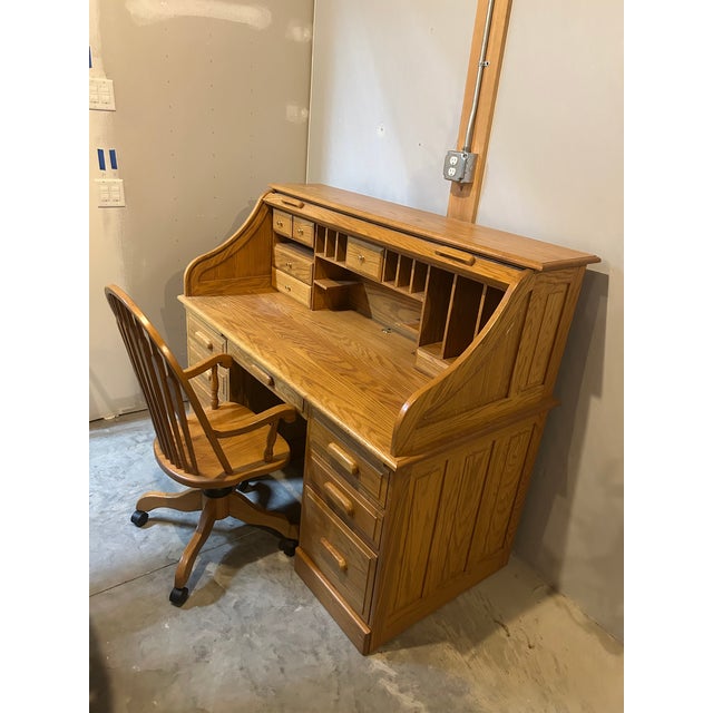 A masterful example of American craftsmanship, this roll-top desk and matching swivel chair were hand-built in 2000 by...