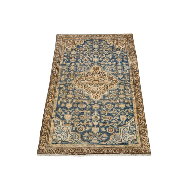 This antique Hamadan rug is hand-knotted from premium wool, boasting a blue field complemented by a captivating, all-over...