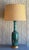 Mid-Century Ceramic Table Lamp with Wooden Base and Brass Accents. The ceramic glaze has a crackled blue finish striped...