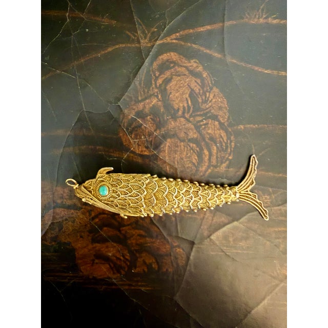 Early 20th Century sterling silver filigree koi pendant with articulating body. Historically dating back to the Middle...