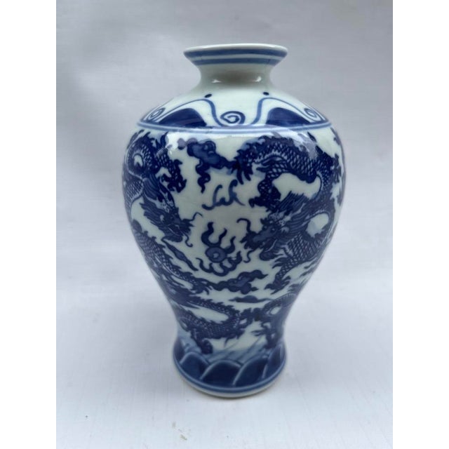 A single small Chinese export porcelain baluster form vase featuring traditional hand painted dragon decoration.