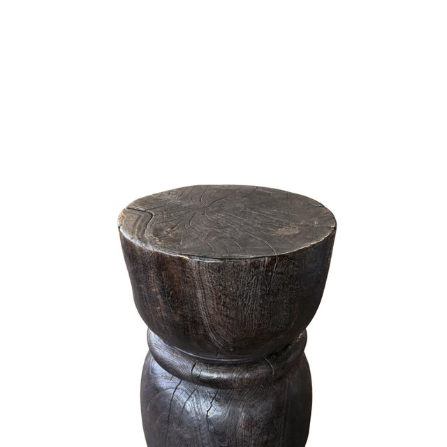 A bold exploration of organic form and artisanal craftsmanship, this sculptural side table is handcrafted from solid suar...