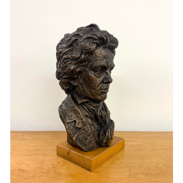 A vintage figural bust depicting a distinguished gentleman in formal attire, rendered with deeply textured, expressive...