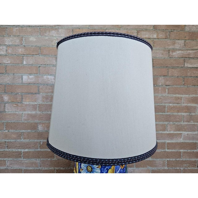 Colorful and lively ceramic table lamp painted with cream lathable cream and blue decorations. Bulb not included. European...