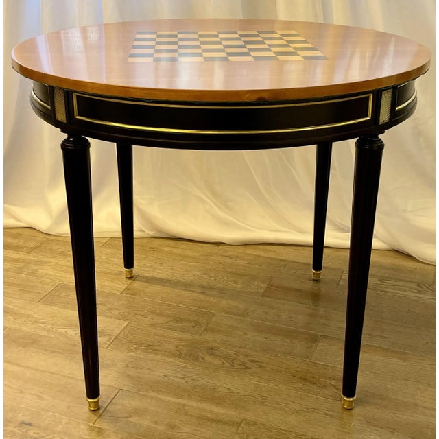 This exquisite Hollywood Regency ebony game or card table is a stunning blend of style and functionality. One side...