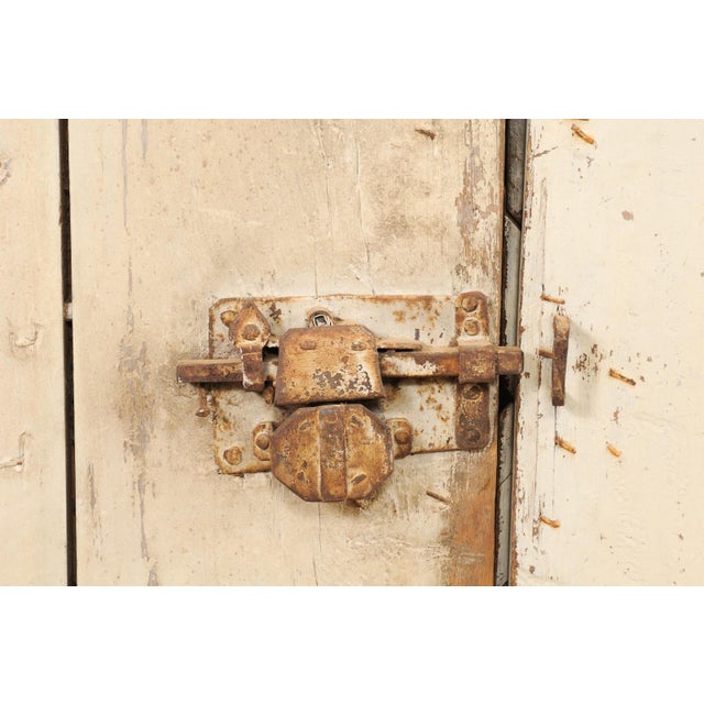 A pair of Swedish doors with geometric patterns and original paint from the 19th century. This pair of antique doors from...