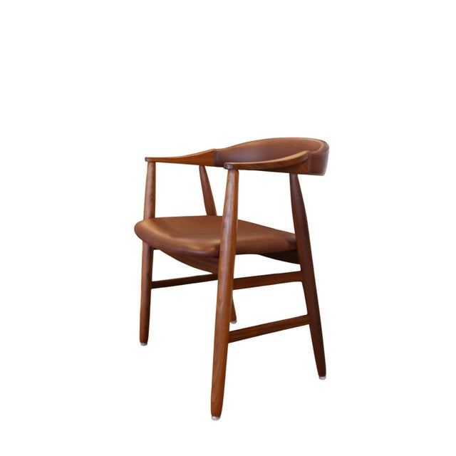 Elegant armchair in dark teak from Farstrup Møbelfabrik, Denmark, where every detail feels well thought out. The coil-...