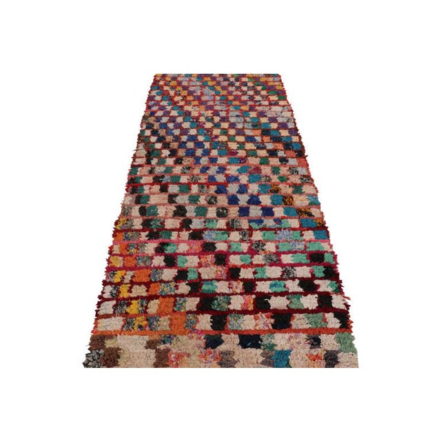 Hand-knotted in wool and originating from Morocco circa 1950-1960, this 3x8 vintage Moroccan rug is an extremely rare...