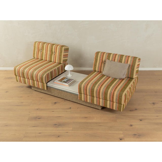 Super cool convertible sofa from the 1970s with the colorful original cover in shades of green, beige, brown and orange...