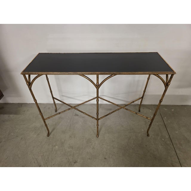 Hollywood Regency-style console table. Refined console table with gold-plated metal frame. Black Perspex top. Designed by...