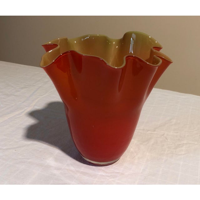 Beautiful red wavy glass vase with creamy interior.