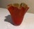 Beautiful red wavy glass vase with creamy interior.