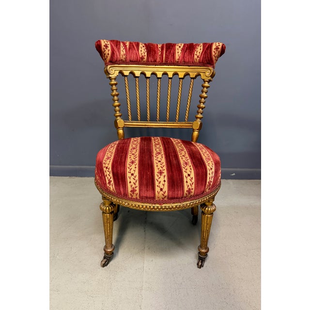 A decorative giltwood side chair made in France during the Napoleon III period, drawing on Louis XVI vocabulary — fluted,...