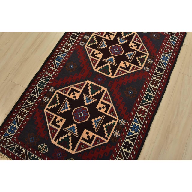 An authentic vintage tribal Baloch rug hand-knotted with fine wool and natural dyes. This nomadic oriental rug features...
