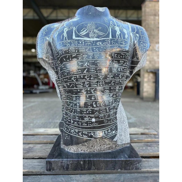 The ancient Egyptian magical statue, a solid marble bust from the 21st century, features intricate hydrographic elements...