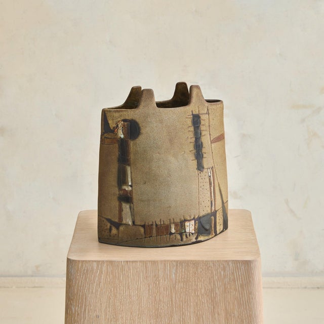 A 1960s ceramic vase crafted by the renowned Faenza Art Institute (F'Arte). This textured piece features an abstract,...