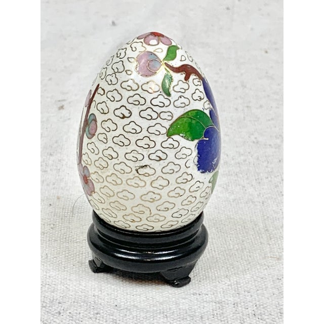 Wonderful vintage cloisonné egg. Colorful and comes with a wooden stand. Features a floral design. Perfect for display!!...