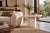 Dating to the 1980s, this pair of Italian mid-century modern travertine side tables showcases the sculptural use of...