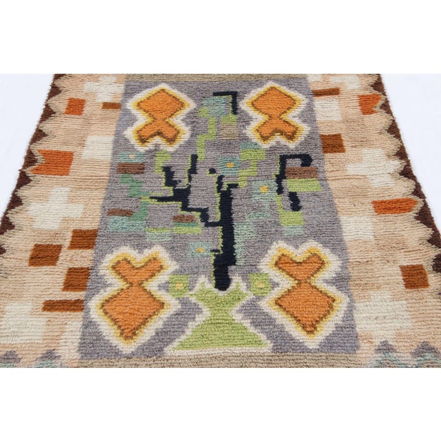 Hand-knotted in lush, high-pile wool in Sweden circa 1960-1970, this 4x6 vintage Swedish Rya rug is a bold new addition to...