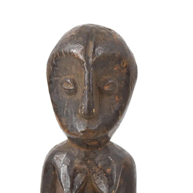 A hand-carved Lega figure originates from the Lega people in the Democratic Republic of the Congo. The figure is easily...