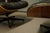 A lovely Eames Lounge chair and ottoman in black leather. The shell of the chair is walnut and the shell on the ottoman is...