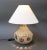 Ceramic table lamp in the style of Georges Pelletier (circa 1970s). An oatmeal colored base glaze forms the background for...