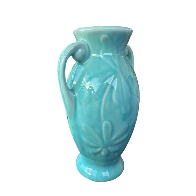 6.5” high x 4” wide (including handles) This demure vase by Shawnee Pottery USA features a lovely aqua turquoise color...