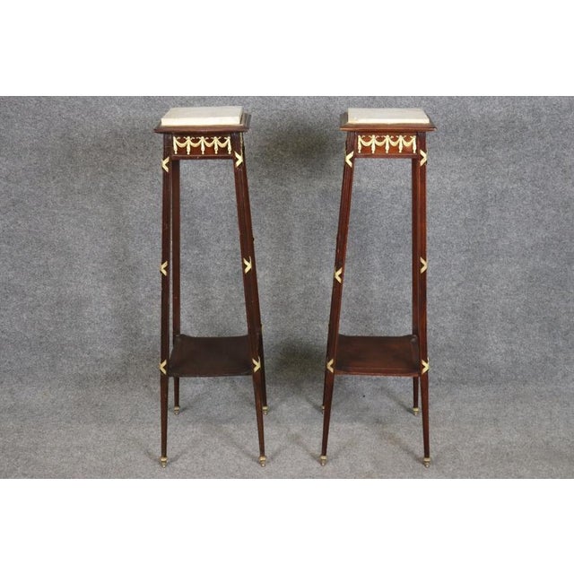 Elevate your interior with this elegant pair of 1930s era walnut pedestals or plant stands, featuring beautifully grained...