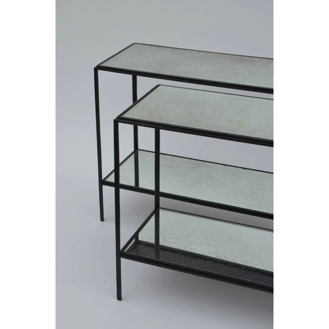 Pair of chic 'Rectiligne' mirrored wrought iron two-tier end / side tables by Design Frères. Lower shelf is at 6 in. from...