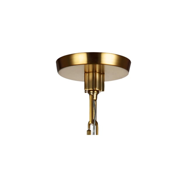 The Sean Lavin Elmore one-light indoor pendant in burnished brass provides abundant light to your home while adding style...