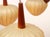 Elegant 1960s pendant lamp. with five identical cocoon shades. Shade diameter 20 cm. Teak wood construction. Fully...