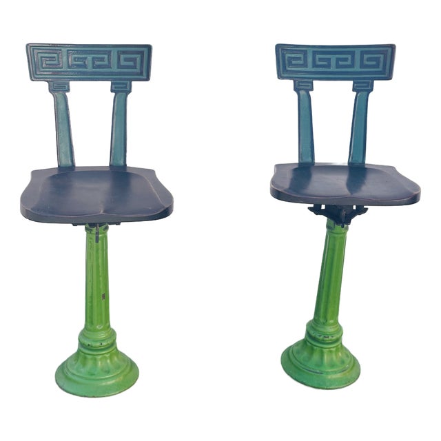 A Pair of Early 20th-Century Cast Iron Soda Fountain Swivel Stools With Greek Key Backs. For Sale